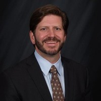 Jonathan Feniak, General Counsel, LLC Attorney seen with a smile on his face 